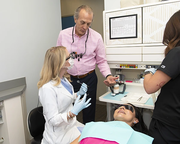 KG Dentistry team discussing a denture treatment with a patient