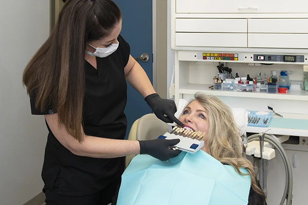 Dental team member preparing a teeth whitening treatment